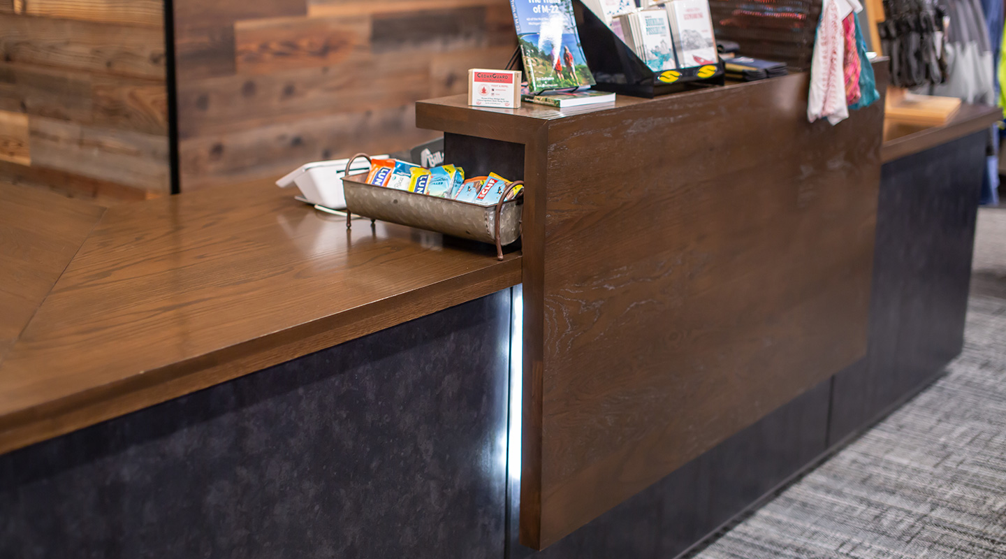 cashwrap: wood countertops, LED-lit transaction top, custom metal face