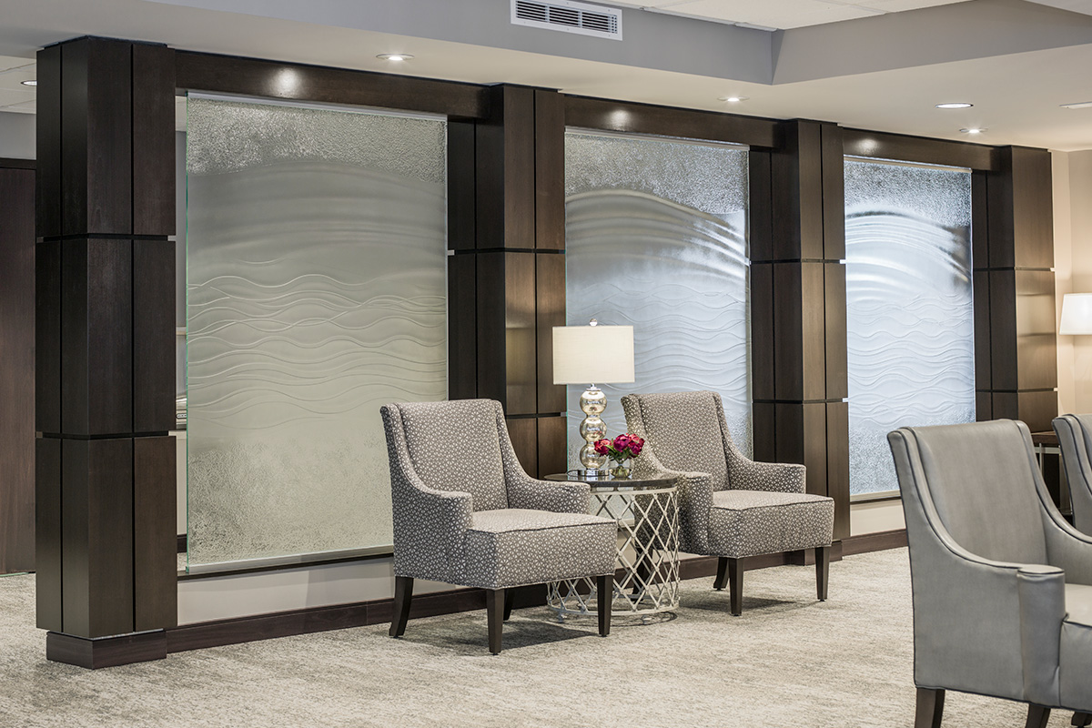 column enclosures in lobby with vertical and horizontal reveals