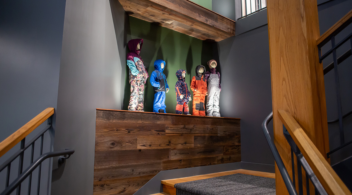 custom stairway shelving and display, with reclaimed redwood cladding