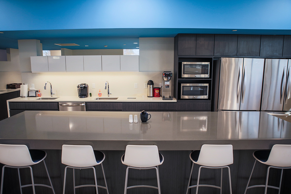 employee lounge kitchenette with wood grain texture laminate cabinetry