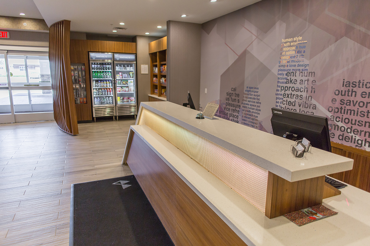 custom teak reception desk with back lighting