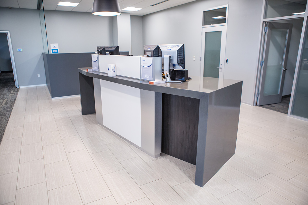 magnetic transaction desk with privacy skirt and solid surface inlay