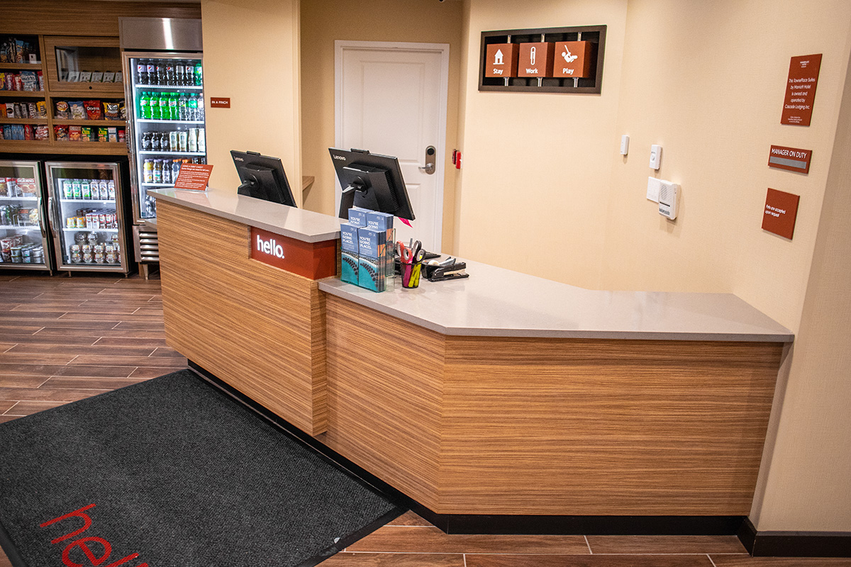 hotel reception desk with built in signage and wall cubes