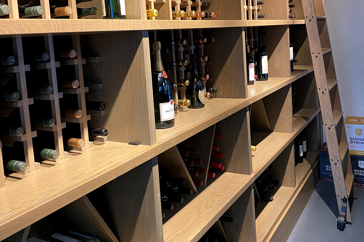 custom cleated wine wall with rolling ladder