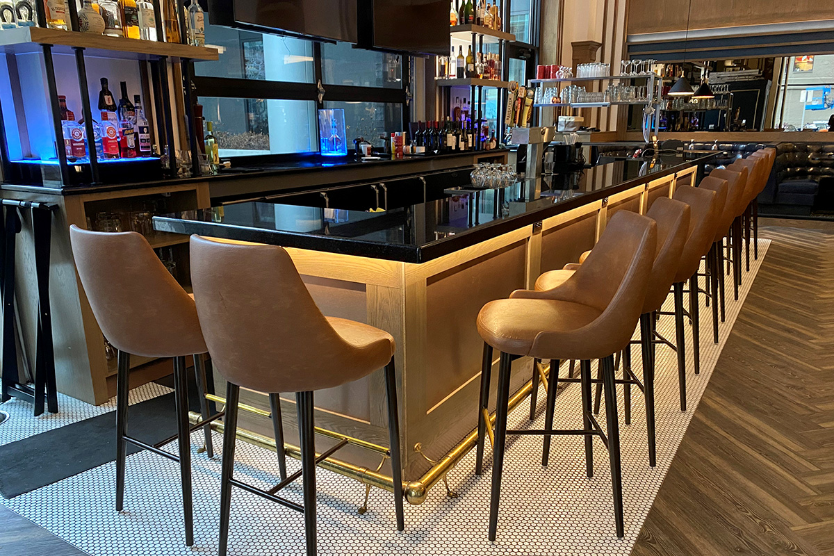 stone topped white oak framed brass paneled bar