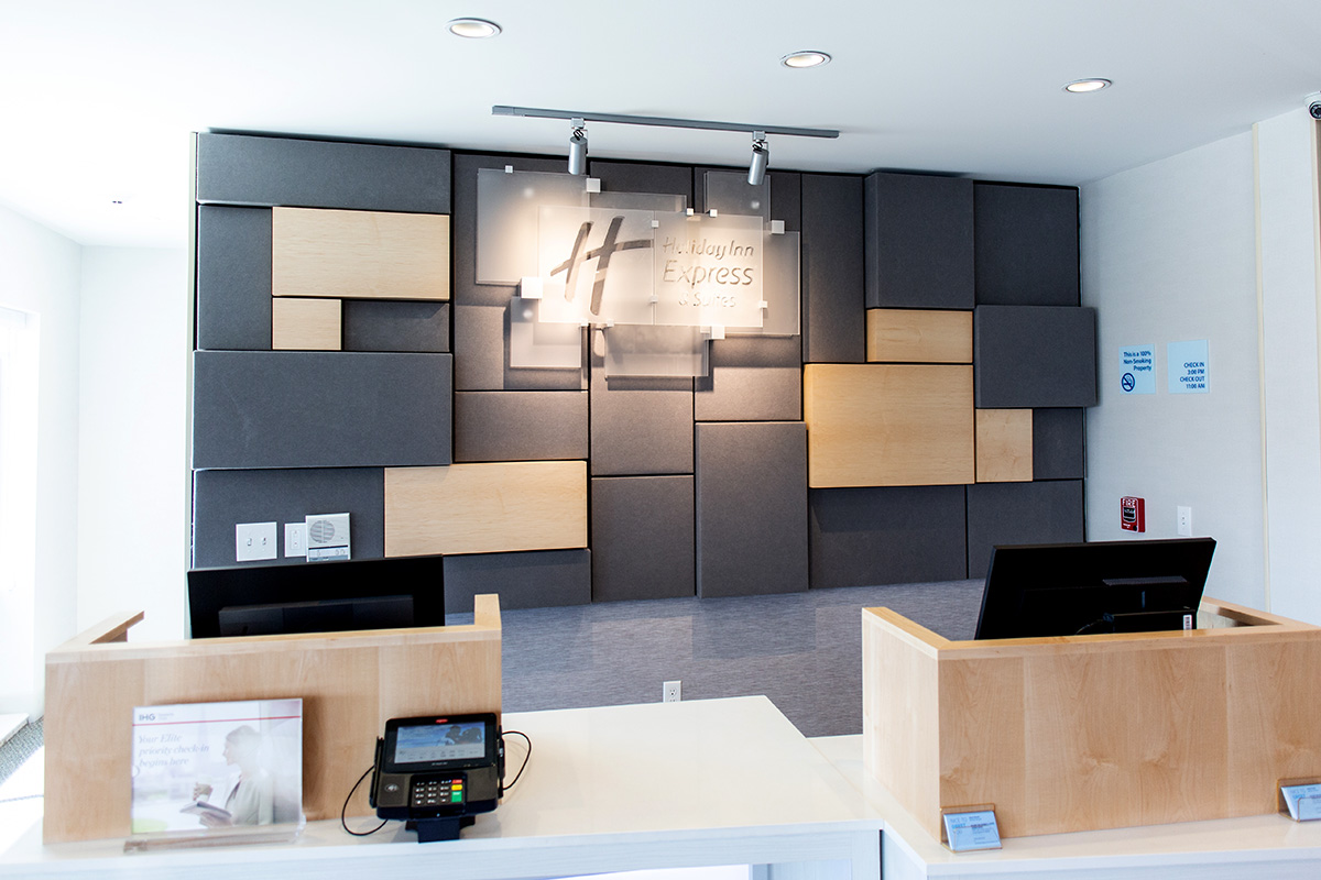 reception desk wall with upholstered and wood panels